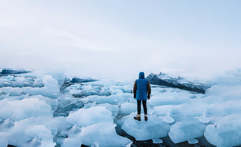 Man standing in front of icy sea
